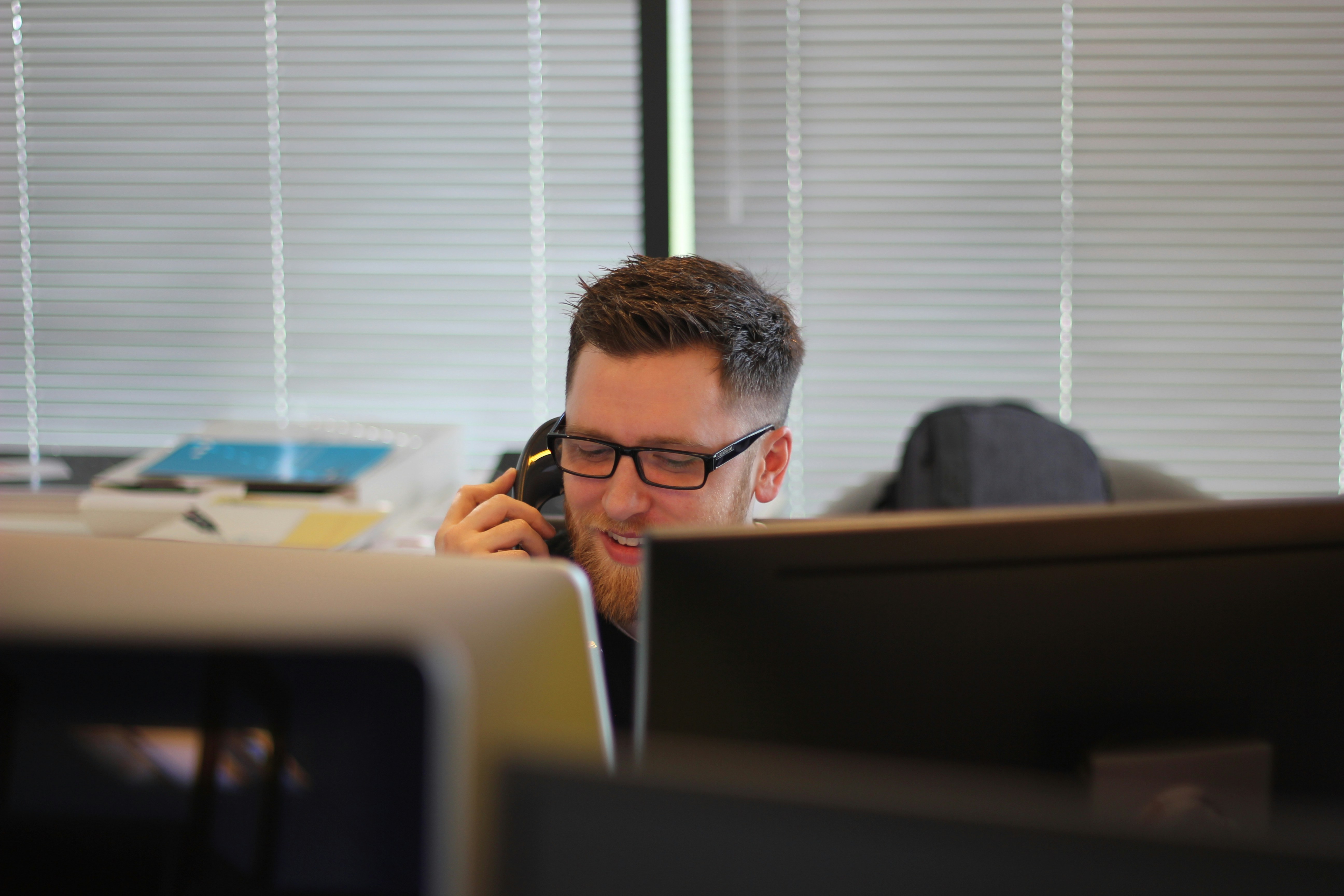 This image shows a representative assisting a client over the phone for an insurance claim.